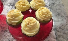 A plate of what looks like lemon blueberry cupcakes.