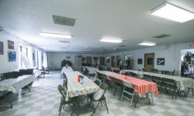 An event room set up with long tables and chairs