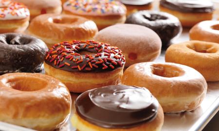 Various donuts spread out on a tray