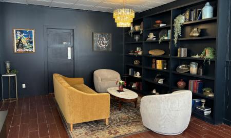 Couches and chairs fill the space with a large bookcase up against the wall