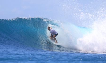 Corey Jackson, founder of the Oldest City Surf School, catching a wave