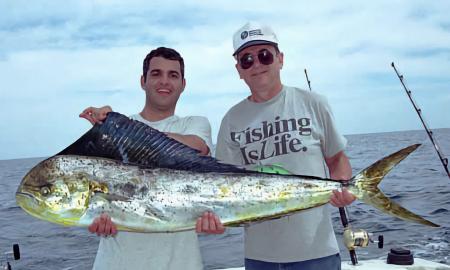 Mahi mahi held up by fishermen