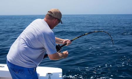 A guest reeling in a fish