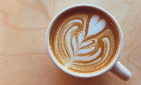 A hot latte with a heart design