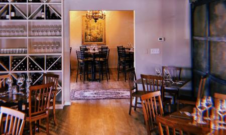 Two dining rooms and a wine shelf at Sogno Restaurant