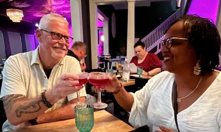 A couple toast at a dinner for two with Tasting Tours