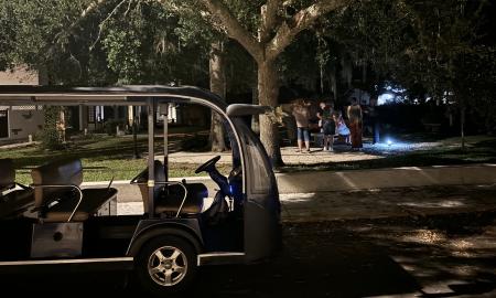 The Land & Sea Ghost Tours EV with guests gathering at the plaza