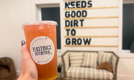 A energy tea drink being held up