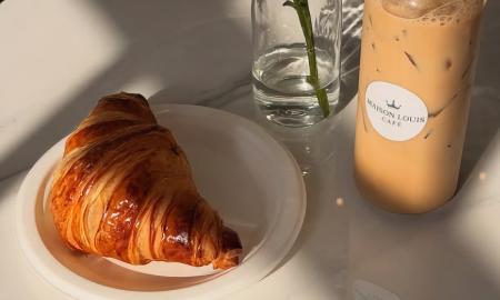 A croissant and iced coffee bottle