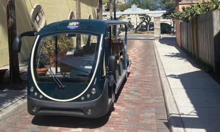 The large, comfortable, electric tour cart for St. Augustine Land and Sea Tours, parked on Aviles Street.