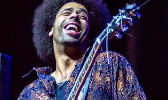 Selwyn Birchwood smiles with his guitar