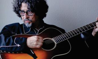 Musician and songwriter Dan Navarro poses with his acoustic guitar. 