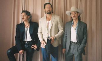 Bandmates from Midland pose in front of a beige backdrop. 