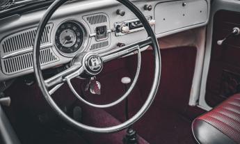 Car interior featuring the vintage Volkswagen Wolfsburg Castle emblem on the steering wheel