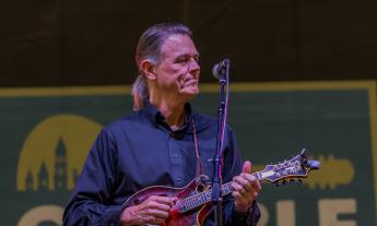 Trey Brewer with his mandolin on the Gamble Rogers stage