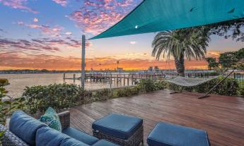 An Airbnb property with a deck facing the water