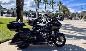 A motorcylce standing near a line of palm trees in Daytona