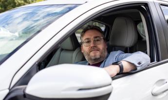 A man in the driver's seat of a car