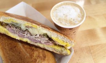 A Cuban sandwich and a cup of hot coffee