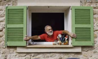 A man looking out the window in "Xueta Island"