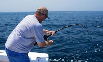 A guest reeling in a fish