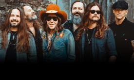 Bandmates from Blackberry Smoke smile and pose in denim jackets. 