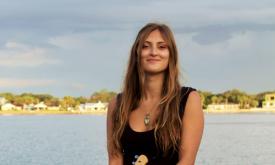 Musician Shyla Macaluso, smiling, at the beach