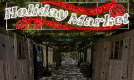 A red and white, AI generated "Holiday Market Sign" over the small buildings at Colonial Quarter