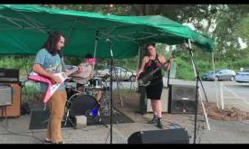 Canine Denim performing at an outdoor venue in Florida.