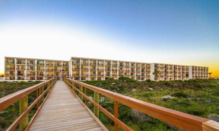 Beacher's Lodge at sunset as seen from the boardwalk to the beach