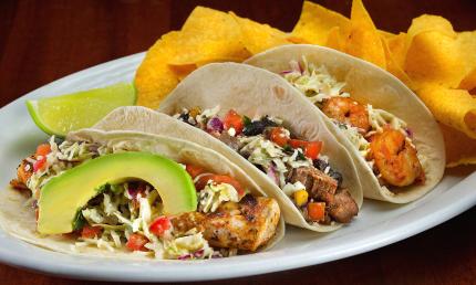 A display of three tacos, fish, meat, and shrimp served at Salt Life Food Shack