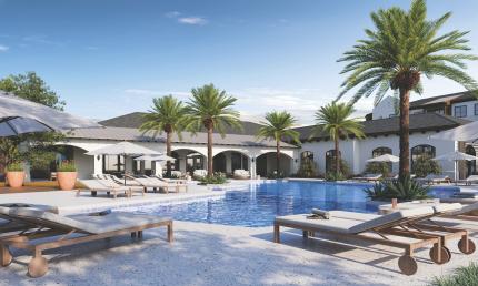 The pool deck at Soluna Apartments shows lounge chairs and a covered area