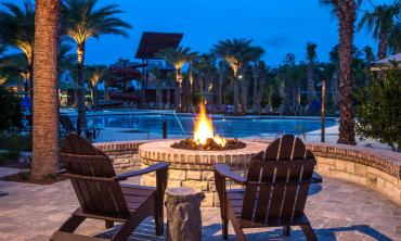 Adirondack chairs around a fire pit at Shearwater