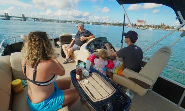 Three generations enjoying the waterway in St. Augustine aboard a rented pontoon boat