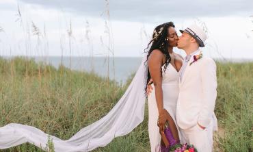 A couple share a kiss on the beach at a wedding arranged by Bayfront Marin House Weddings