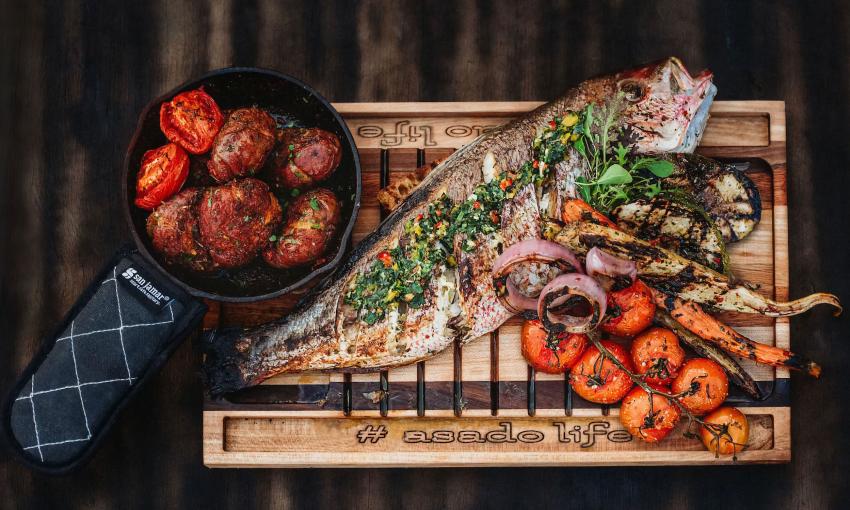 A plater of food cooked on a live-fire grill at Asado Life
