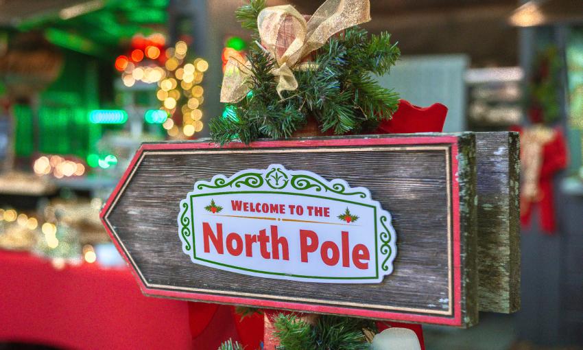 A sign directing people to the "North Pole" where they can find pastries